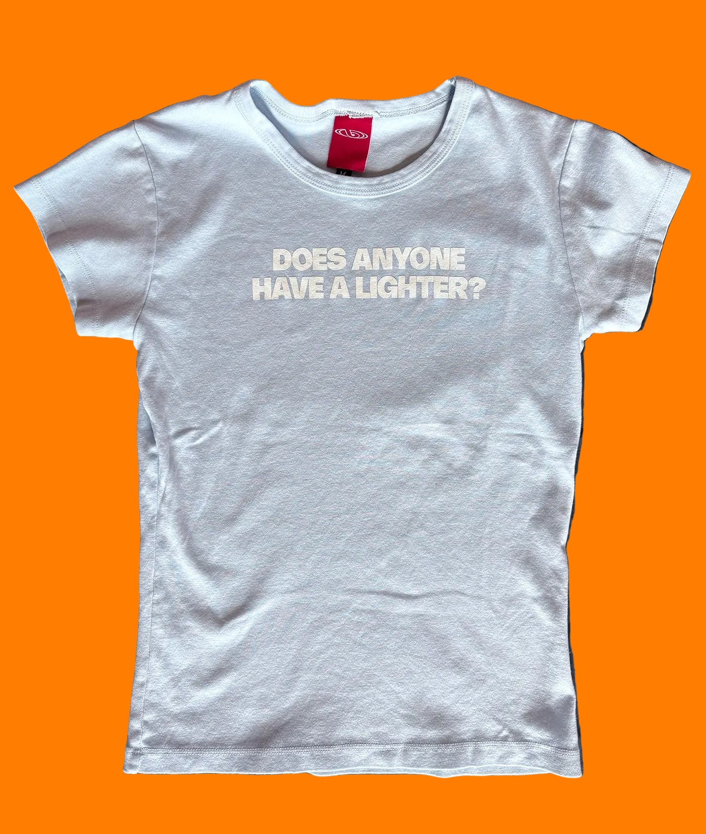 BY.Everyone light blue baby tee with the words "Does Anyone Have A Lighter?" printed on the center chest in white.
