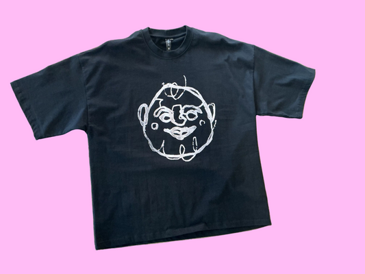 Black t-shirt with a pink graphic design on a textured surface