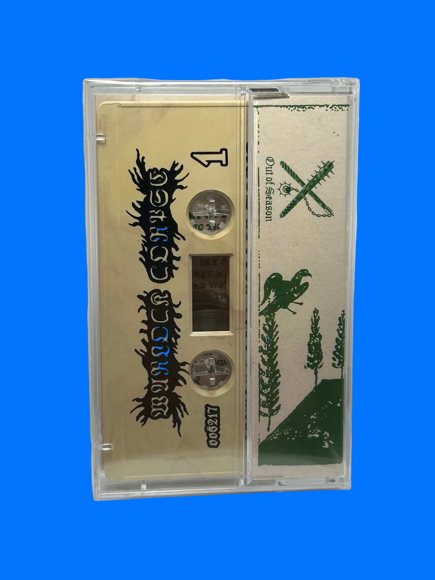 Cassette tape with green and black design on a white background warlock corpse