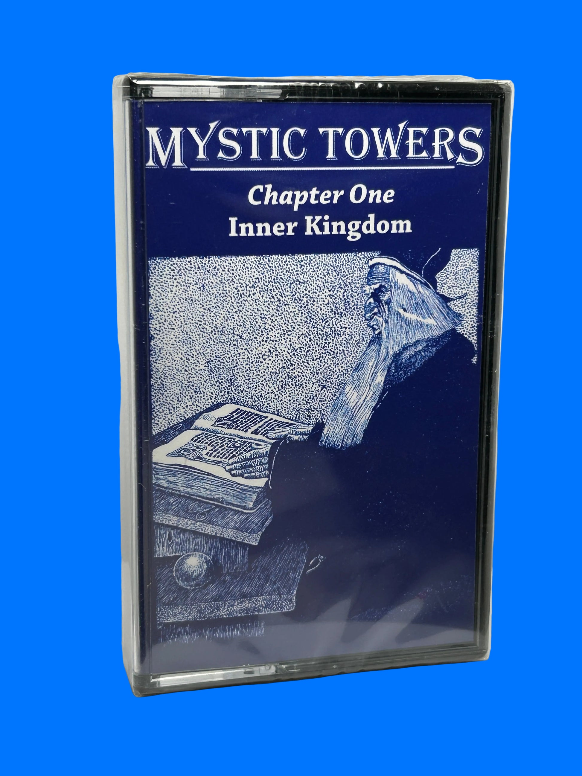 Cassette tape with 'Mystic Towers' cover featuring a mountain and text on a white background