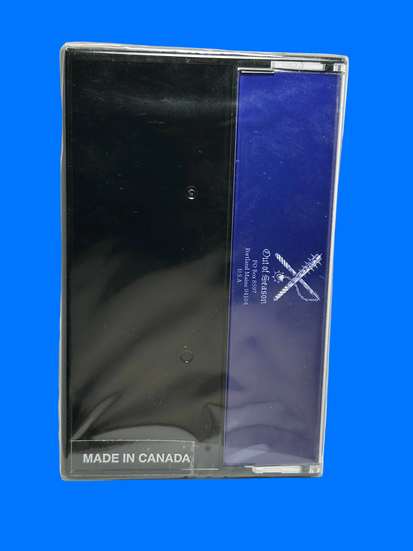 Black product in clear packaging with blue label on a white background mystic towers