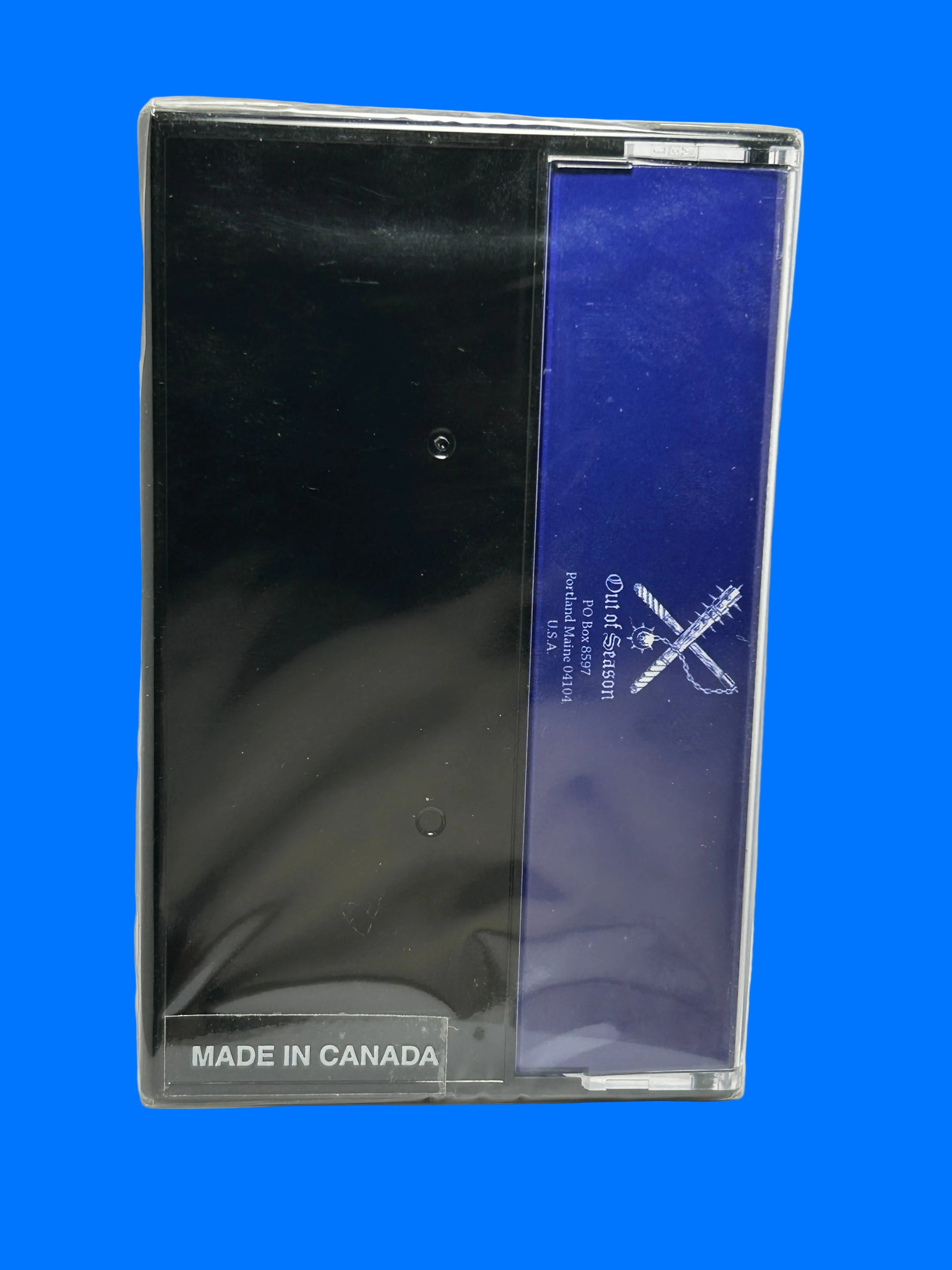 Black product in clear packaging with blue label on a white background mystic towers