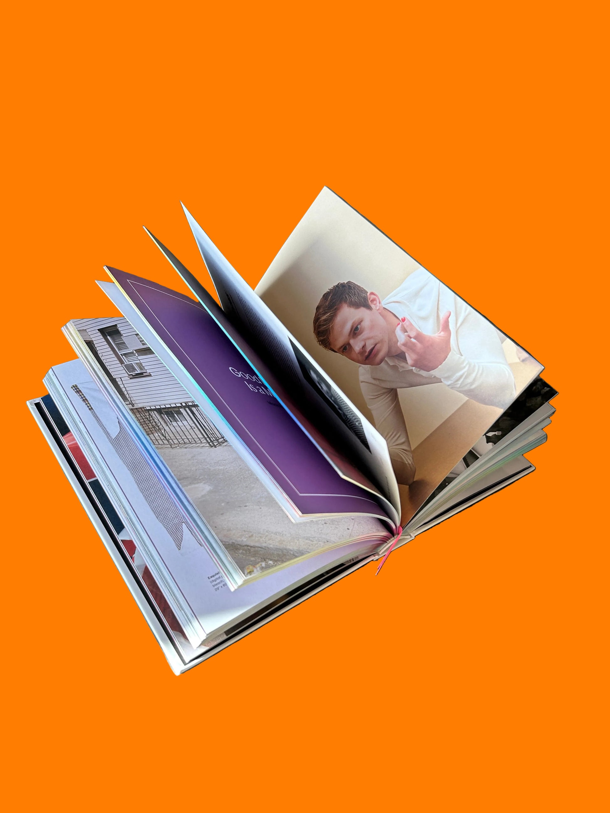 Stack of photo books on a textured surface a great gay book