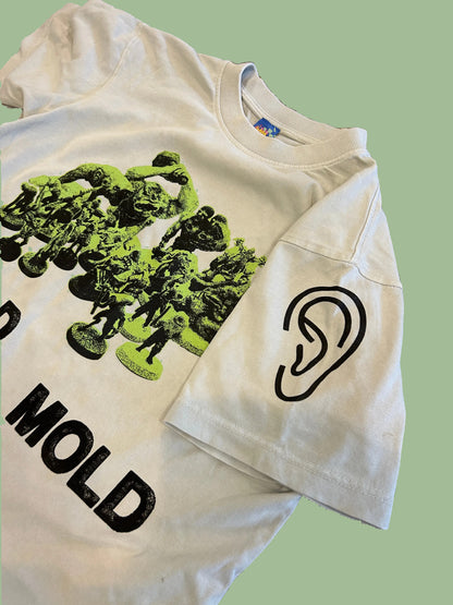 White t-shirt with green graphic and black text on a textured surface mold mold mold