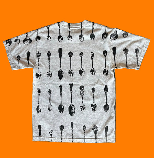 Back of the BY.Everyone heather grey shirt with all-over spoon pattern print in black. 